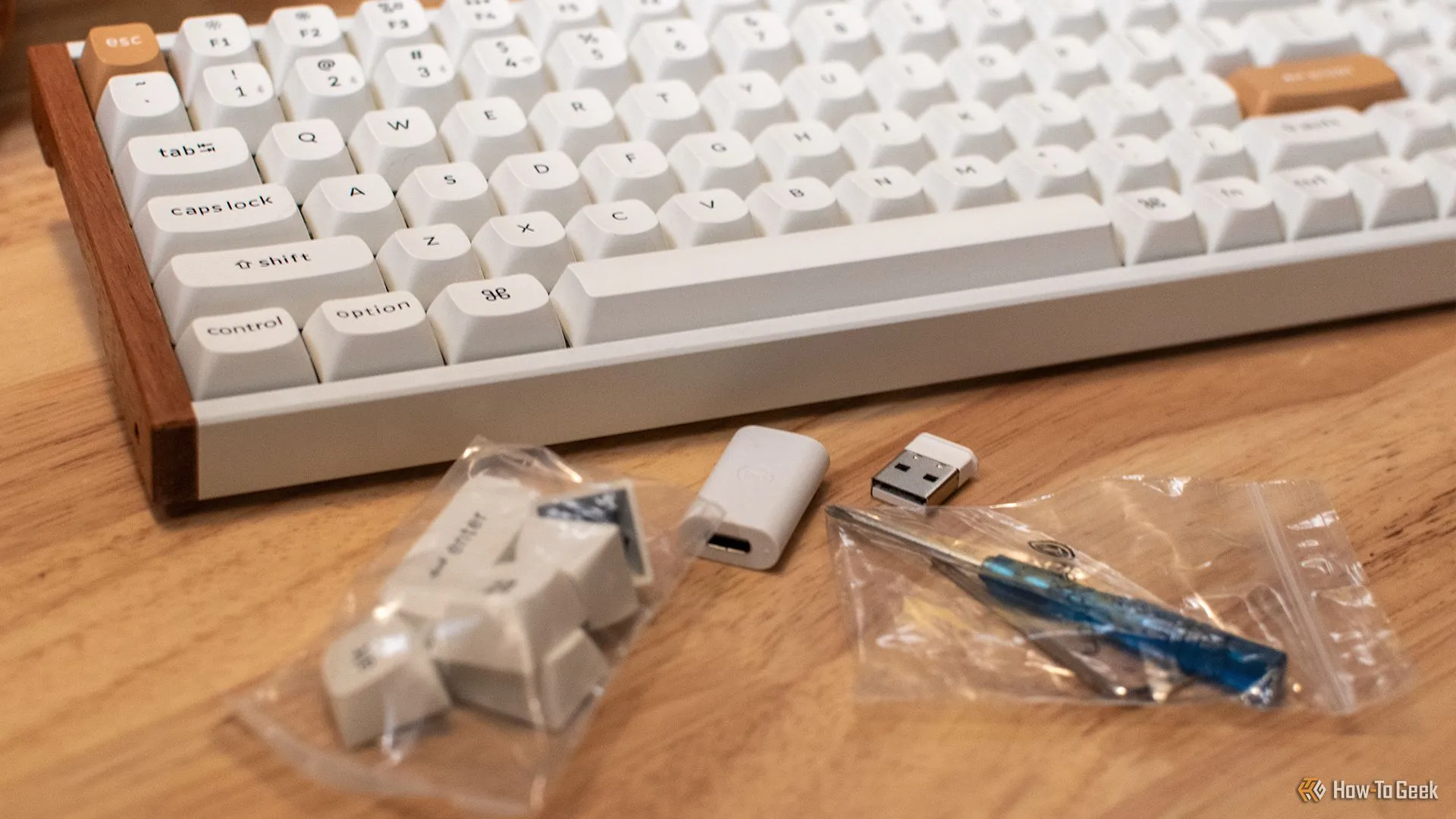 Bàn phím Keychron K4 HE và các phụ kiện đi kèm như keycap Windows, công cụ tháo keycap và switch.