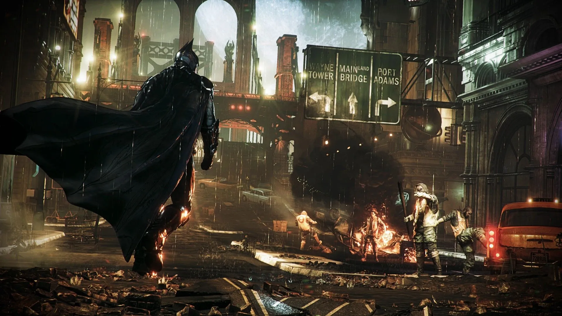 Batman tiến về phía nhóm tội phạm đang phá hoại thiết bị trong game Arkham Knight.