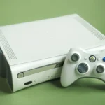 Máy chơi game Xbox 360 màu trắng cùng tay cầm, biểu tượng của kỷ nguyên thành tích game hiện đại.