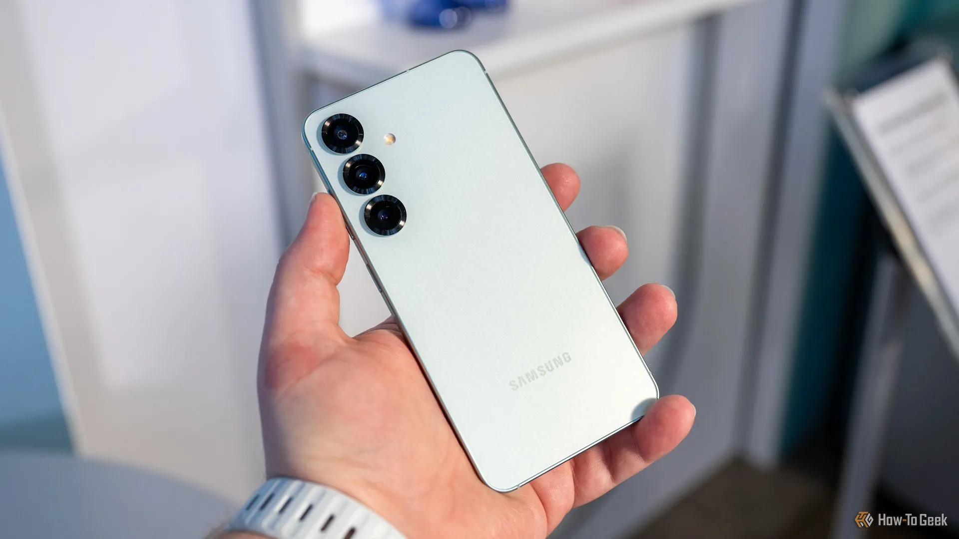 Người dùng cầm điện thoại Samsung Galaxy S25 hiển thị cụm camera sau